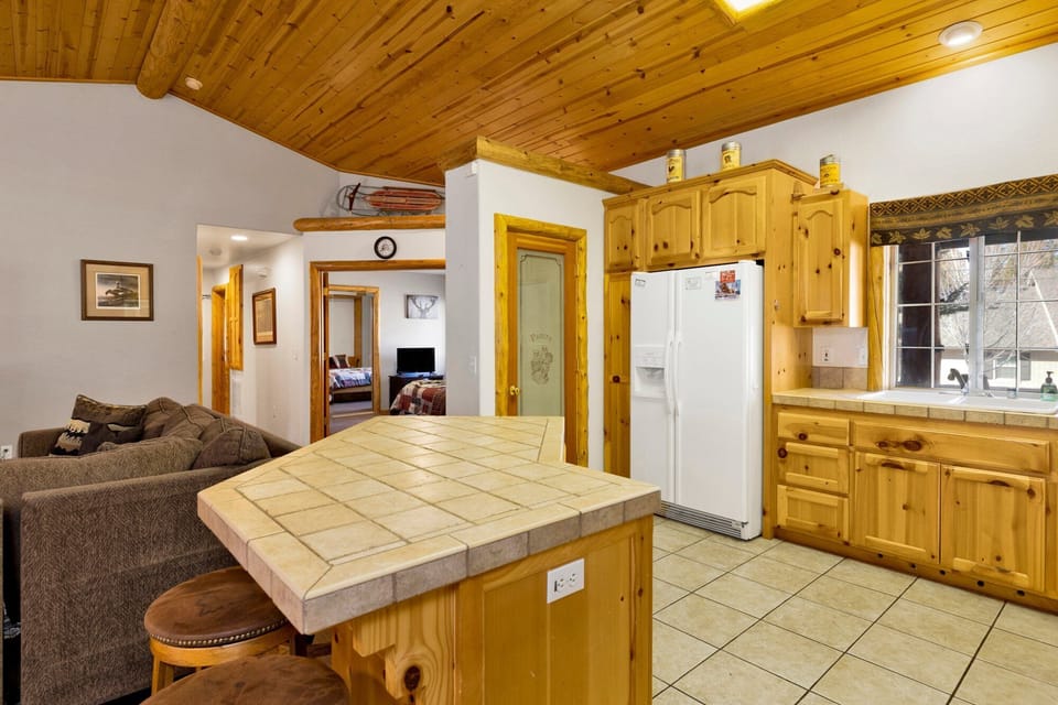Fully equipped cabin kitchen with ample cabinetry, stove, fridge, microwave, and coffee maker—perfect for cooking meals, morning coffee, and feeling right at home on your stay.