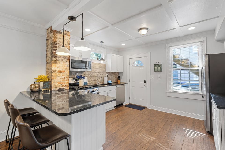 View of the kitchen area and the back entry door from the living room. 