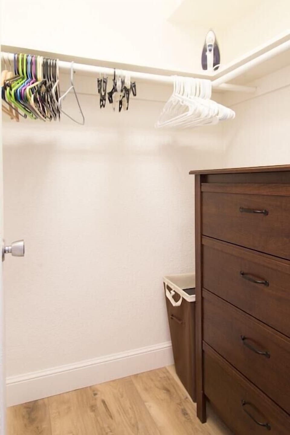 2nd bedroom suite walk-in closet includes dresser of drawers and lots of hangers