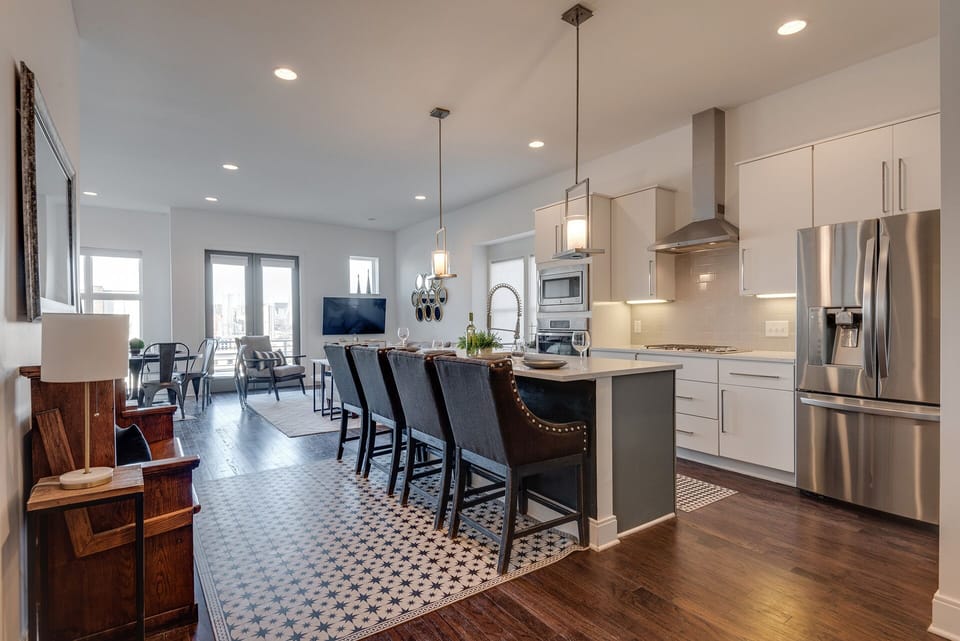 2nd Floor: Fully equipped kitchen, complete with stainless-steel appliances and a kitchen island with ample counter space and bar seating.