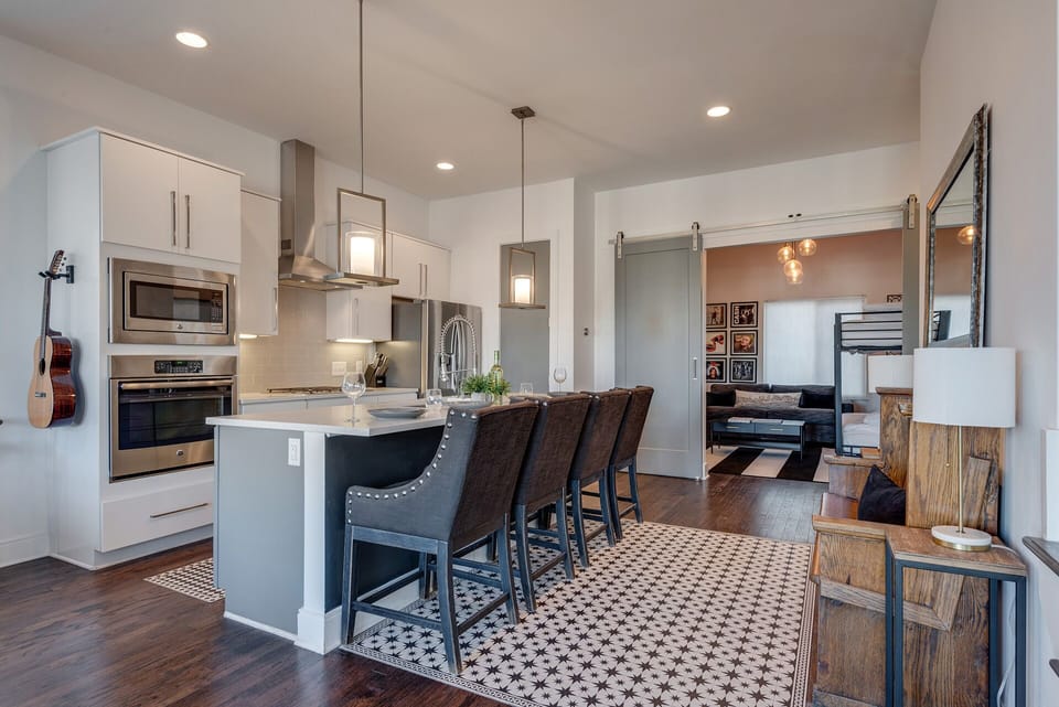 2nd Floor: Fully equipped kitchen, complete with stainless-steel appliances and a kitchen island with ample counter space and bar seating.