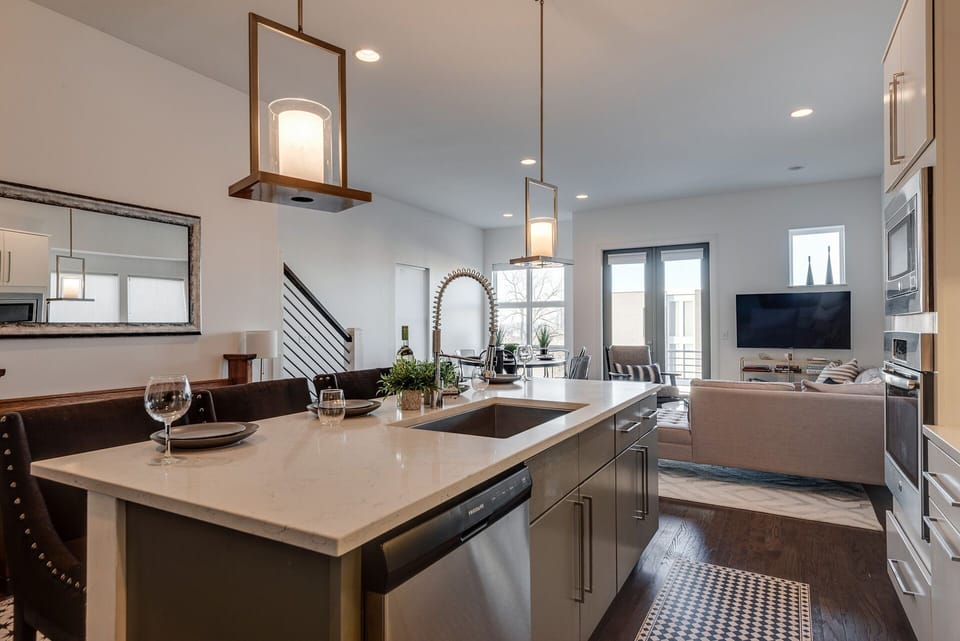 2nd Floor: Fully equipped kitchen, complete with stainless-steel appliances and a kitchen island with ample counter space and bar seating.