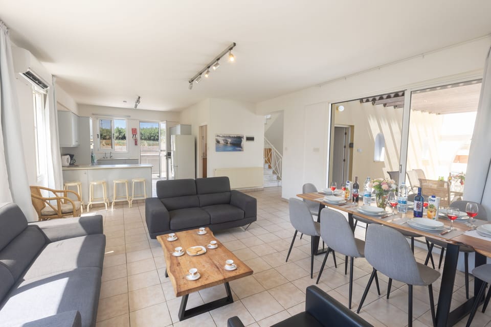 Living room with comfortable sofas, coffee table and widescreen satellite TV