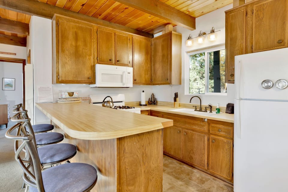 A modern kitchen featuring sleek granite countertops, stainless steel appliances, and ample cabinet storage. T