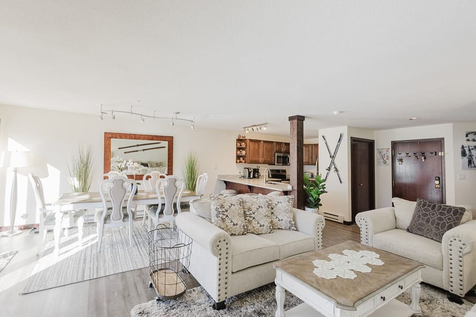 Dining table, living room, and kitchen.