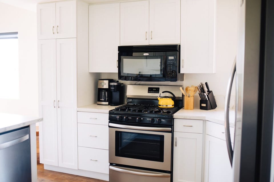 Stainless steel appliances, gas stove and oven, dishwasher and microwave. 