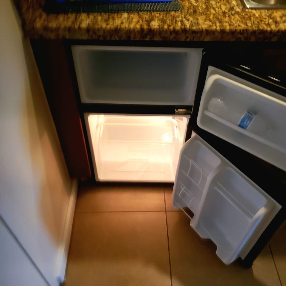 Kitchenette includes small refrigerator/freezer.