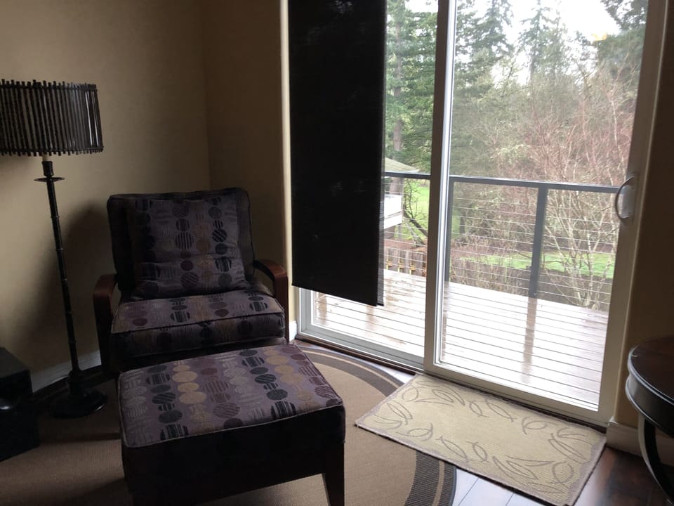 Living room with balcony overlooking greenspace