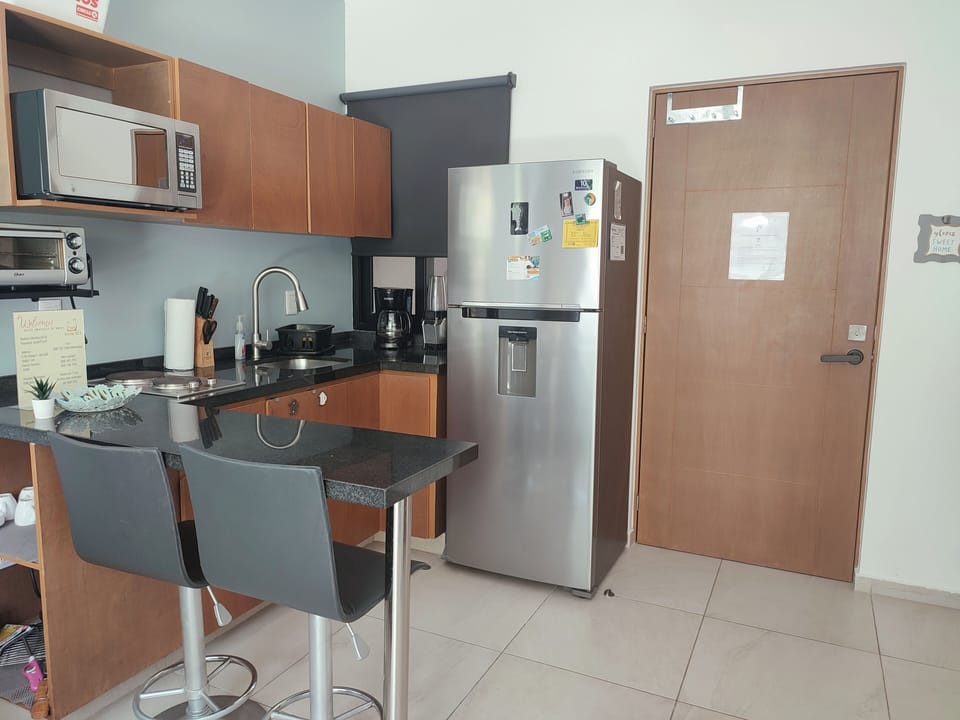 Full Kitchen  with two stovetop burners, toaster over, blender, coffee machine.