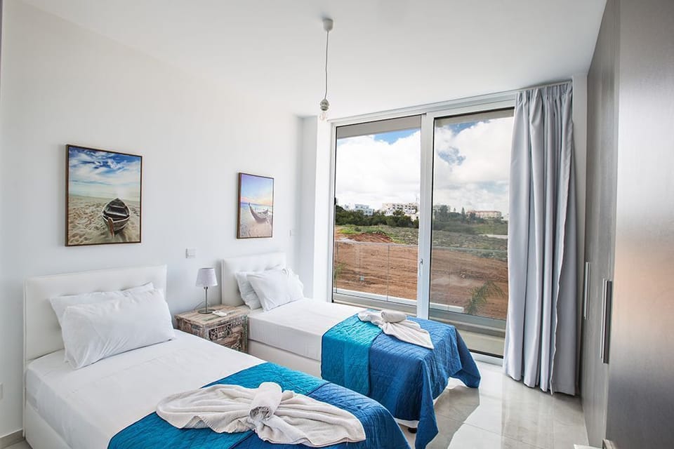 Bedroom 3 with two single beds and shared balcony