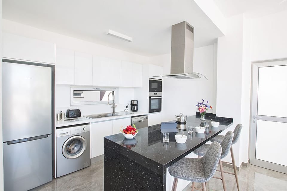 Fully Equipped kitchen complete with island and extra seating for 3 people