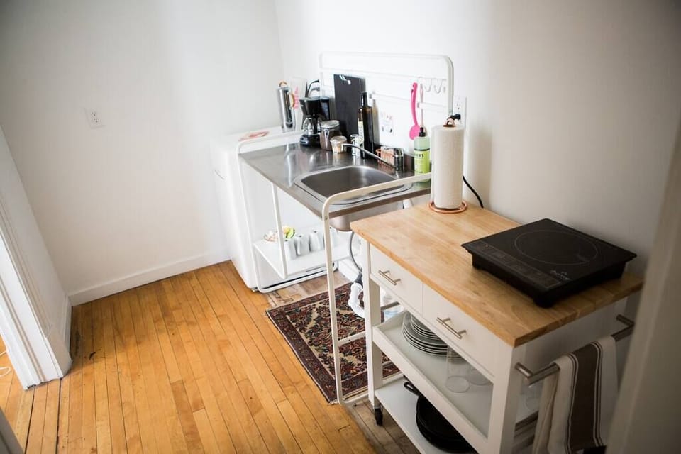 Your kitchenette, complete with an induction burner, coffee maker, mini fridge and all the basics for cooking and eating.