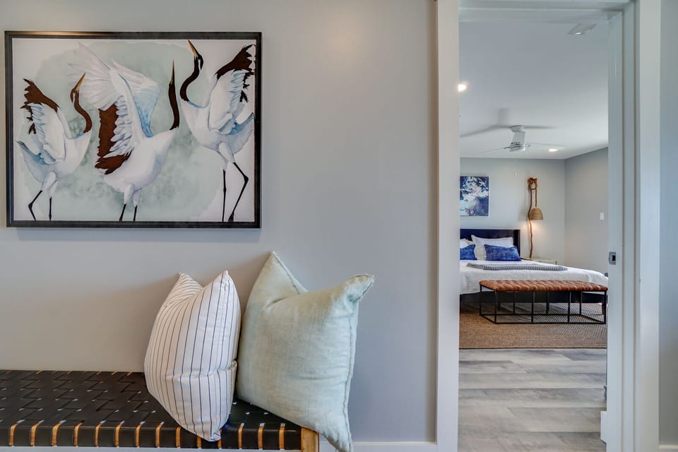 Your thoughtfully designed space welcomes you with elegant crane artwork and soft seating leading to a restful bedroom sanctuary.