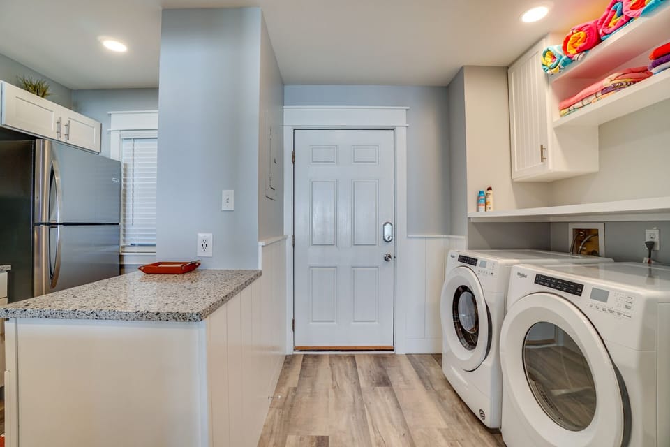 Your kitchen seamlessly flows into a convenient laundry area, making meal prep and chores effortless during your stay.
