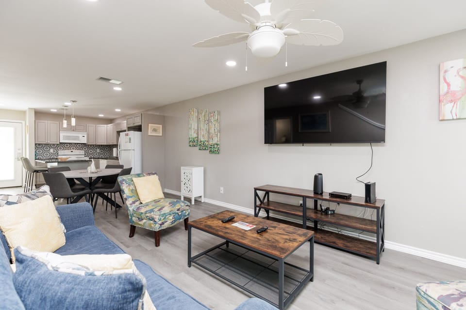 Relax in your spacious open-plan living area with modern furnishings, large-screen TV, and stylish kitchen—perfect for unwinding after exploring.