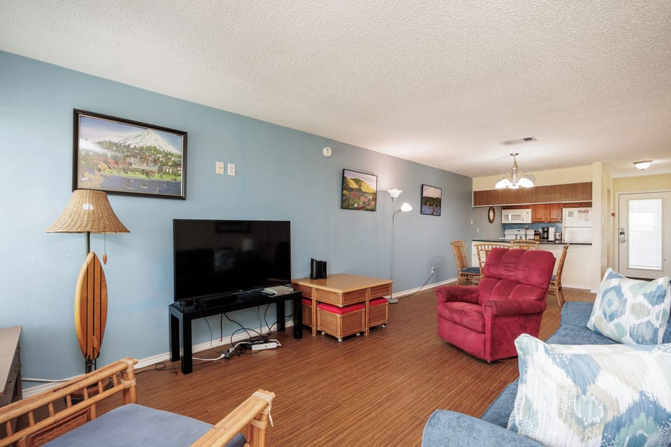 Relax in your spacious living room with plush seating, large TV, and coastal-inspired decor that creates the perfect home base for your getaway.