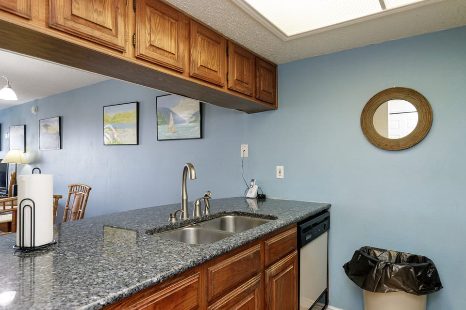 Your well-appointed kitchen features granite countertops and warm wood cabinetry, creating the perfect space for preparing meals during your stay.