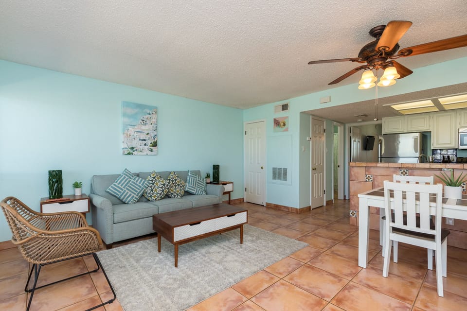 Relax in your bright, coastal-inspired living space with comfortable seating and open-concept design flowing into your fully equipped kitchen.
