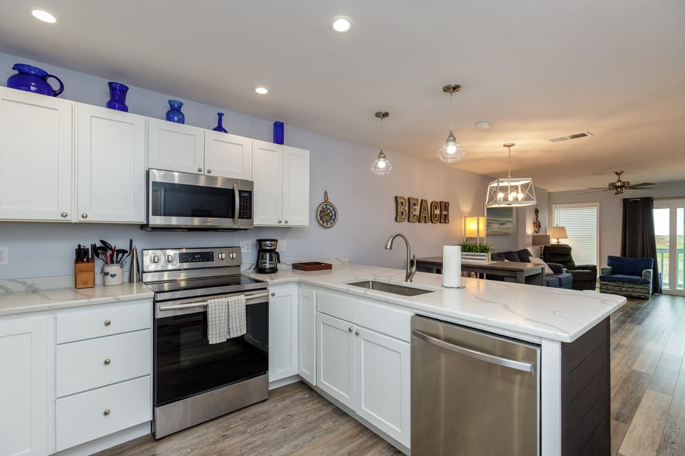 Your fully equipped kitchen invites culinary adventures with stainless steel appliances and spacious marble countertops.