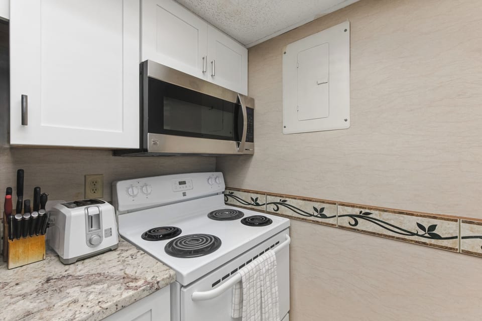 Your fully equipped kitchen awaits with modern appliances and granite counters, perfect for preparing memorable meals during your stay.