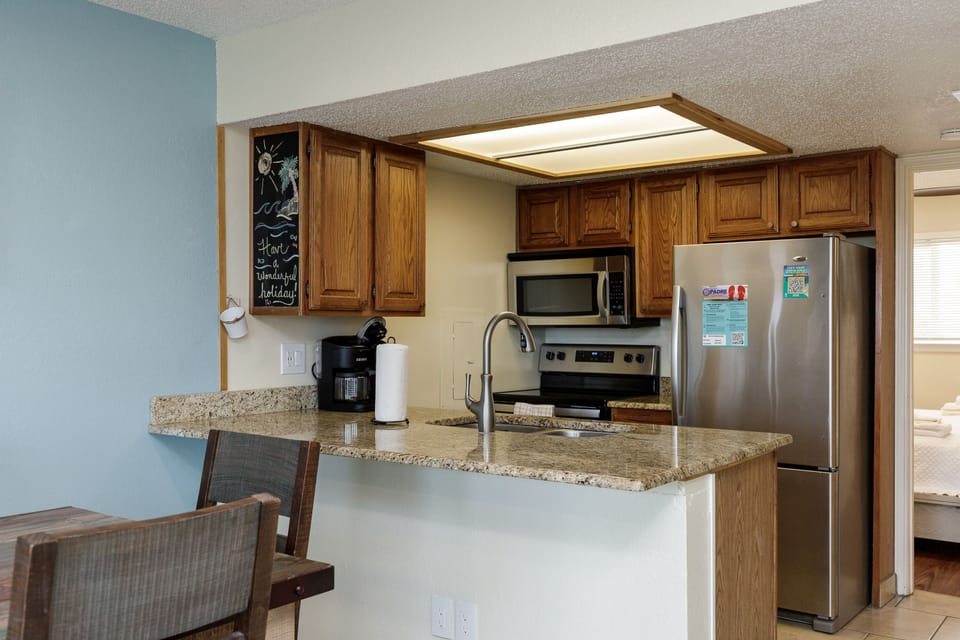 Your fully equipped kitchen features granite counters, stainless appliances, and everything needed to create memorable meals during your stay.