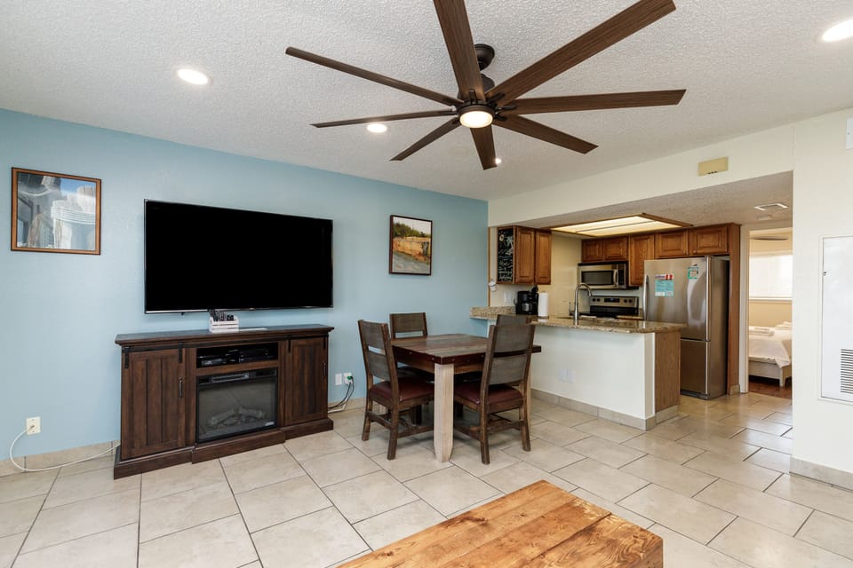 Relax in this open-concept space where coastal colors meet modern comfort. Your entertainment center and dining area flow seamlessly into the fully-equipped kitchen.