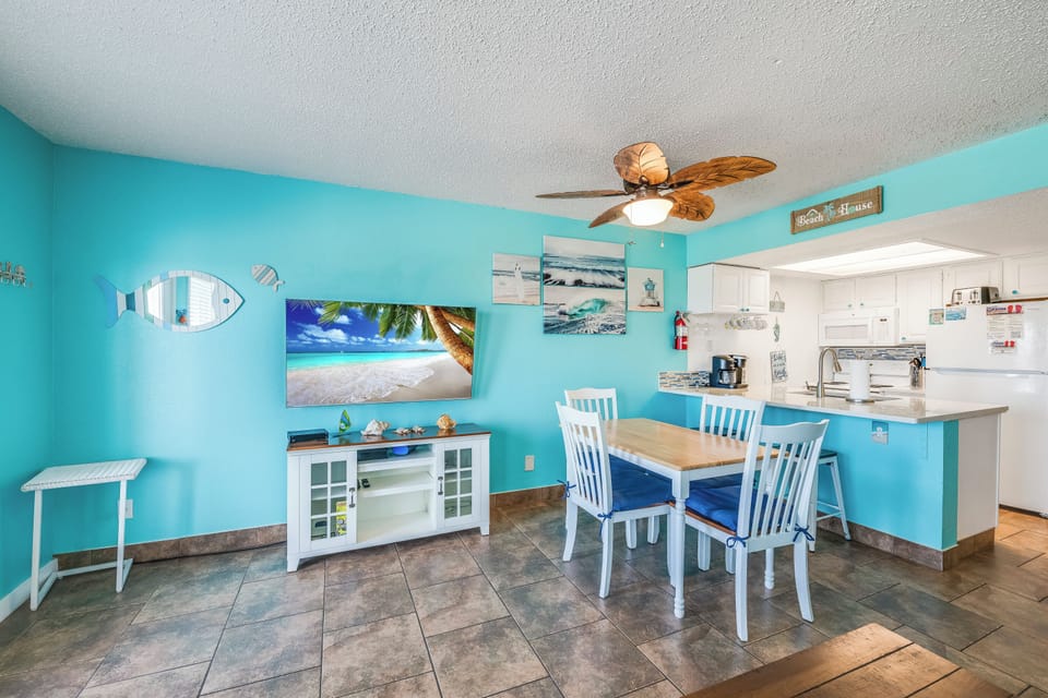 Picture yourself enjoying morning coffee in this cheerful coastal space, where ocean breezes meet beach-inspired décor. Your open dining and kitchen area invites relaxed meals and easy conversation.