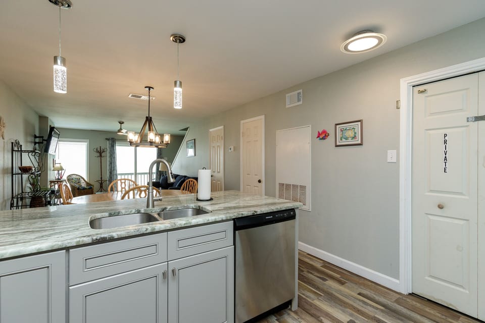 Prepare meals with ease in your stylish kitchen featuring granite counters and stainless steel appliances.