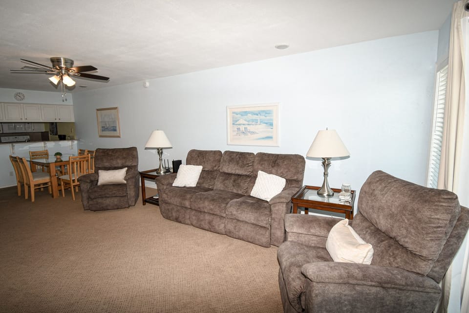 Relax in your spacious living room with plush seating, soft lighting, and an open layout connecting to your fully equipped kitchen.