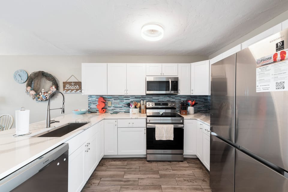 Your fully equipped kitchen features stainless steel appliances, coastal charm, and everything you need to create memorable meals together.