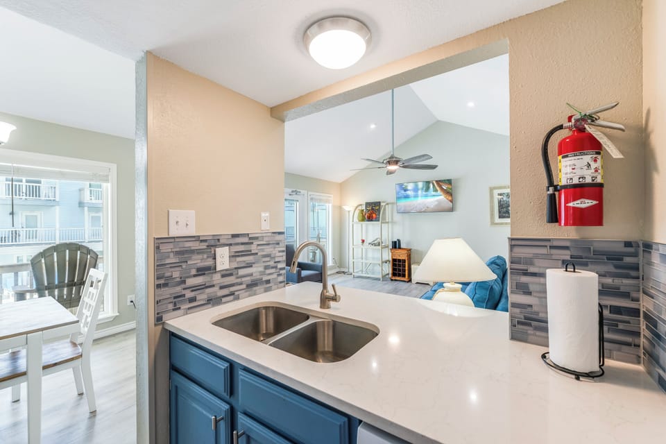 Your modern kitchen flows seamlessly into the living area, with sleek countertops and stylish backsplash creating the perfect space to cook and connect.