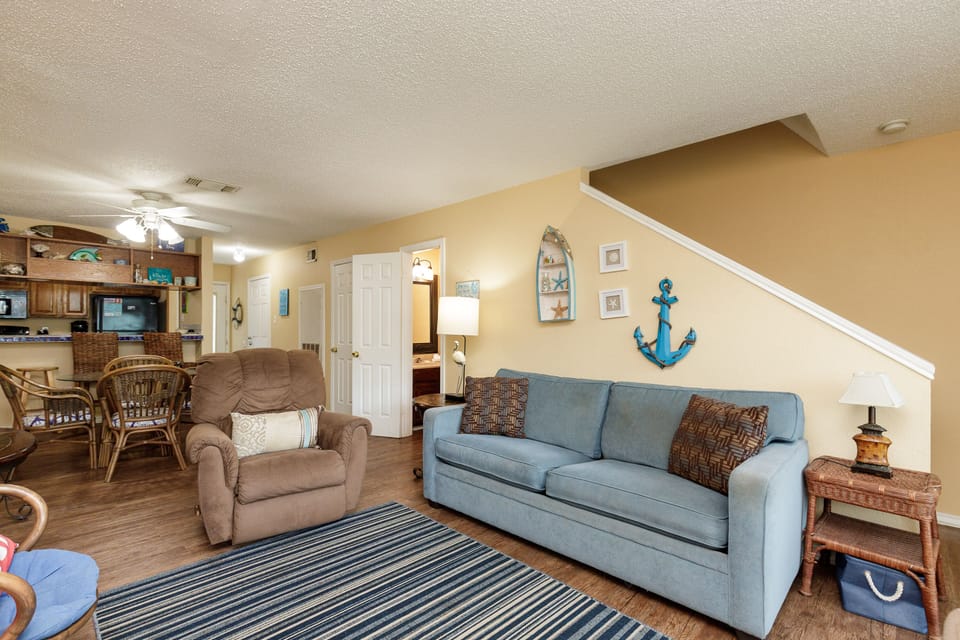 Relax in your coastal-themed living space with comfy seating and nautical touches throughout.