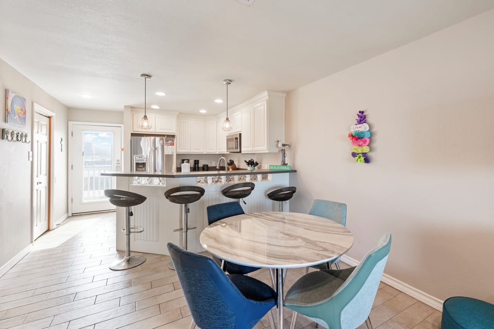 Your open-plan kitchen flows seamlessly into a bright dining space, perfect for morning coffee or evening meals with loved ones.