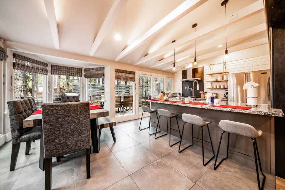 The open-concept kitchen and dining area with views of the backyard.