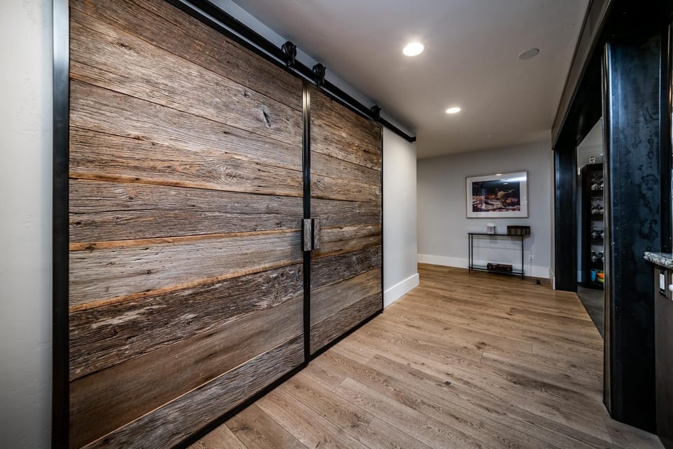 Antique wood barn-style sliding doors can be used to close the living room.
