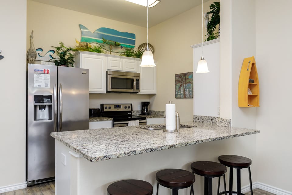 Your fully equipped kitchen features granite countertops, stainless appliances, and a breakfast bar where you can enjoy morning coffee.