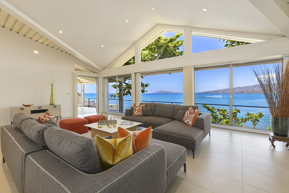 Unwind in the spacious family room where floor-to-ceiling windows frame the sparkling Pacific.