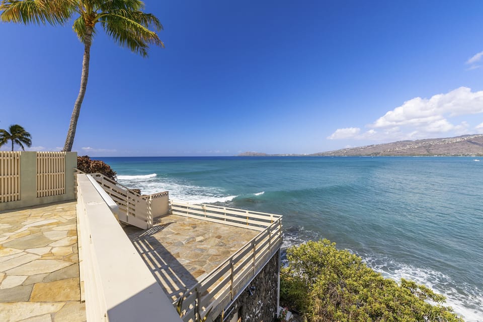 Enjoy outdoor dining at the barbecue deck, complete with a shaded awning and panoramic ocean views.