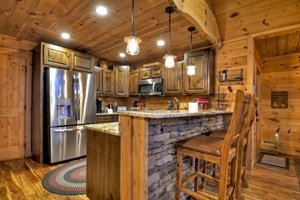 Well stocked kitchen with ample counter top space and counter space seating for 2.