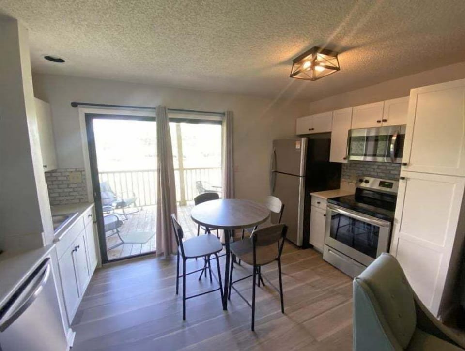 Kitchen area containing full-size stainless steel appliances