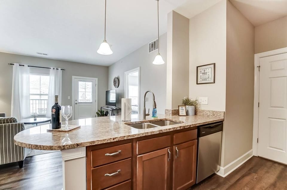 The kitchen features stainless steel appliances and lots of space on the granite countertops!
