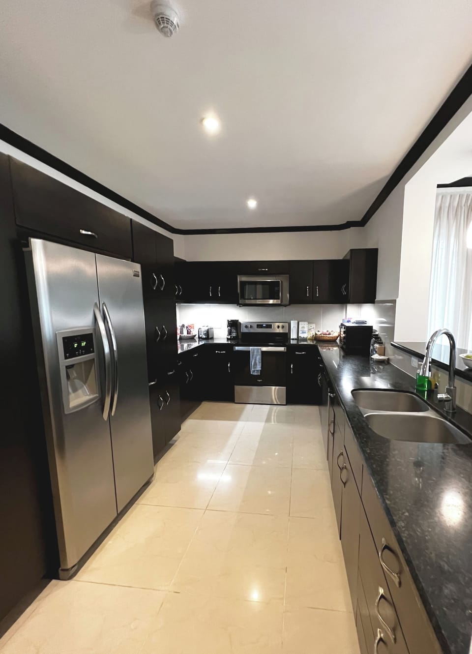 Large and well-stocked kitchen with granite and stainless steel