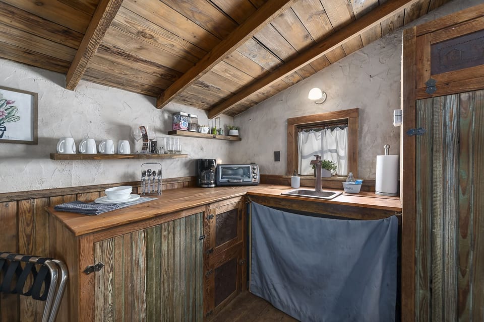 Rustic kitchen with a Mini fridge, microwave, coffee maker and toaster oven