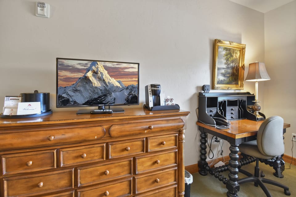 Guest bedroom has a work space for travelers that need to work while traveling