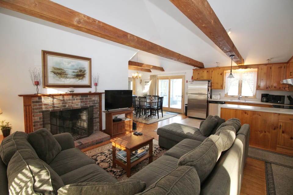 Family room with vaulted ceiling and flat screen TV