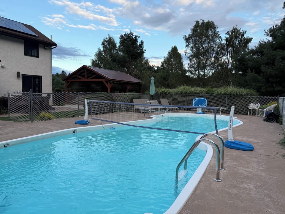 Private pool with basketball hoop and volleyball