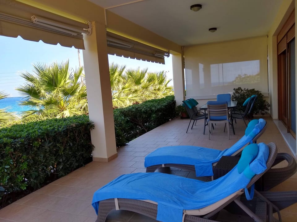 Veranda with dining space and cushioned lounges
Oceanis Suite