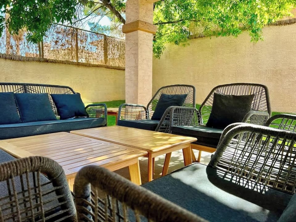 Enjoy the outdoor seating with fans above and trees around