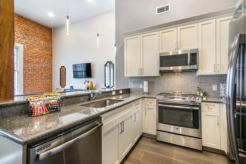 Cook and dine easily in the fully stocked kitchen, equipped with all stainless steel appliances, gas range, basic cookware, and a dining area for a comfortable meal at home. Entertain at the bar with seating for four.