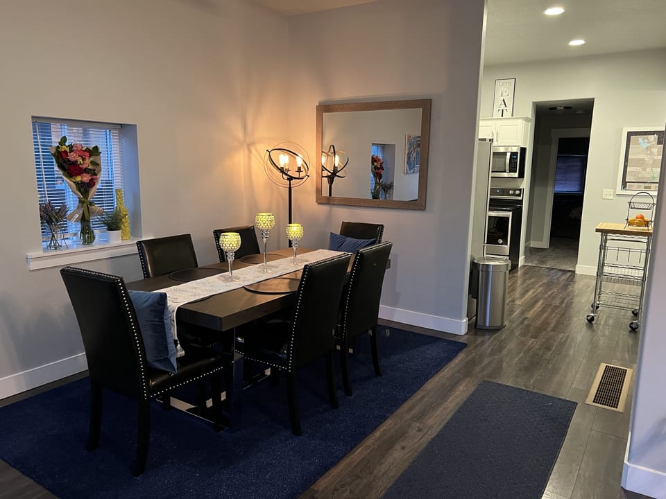 Dining room table with view of kitchen.